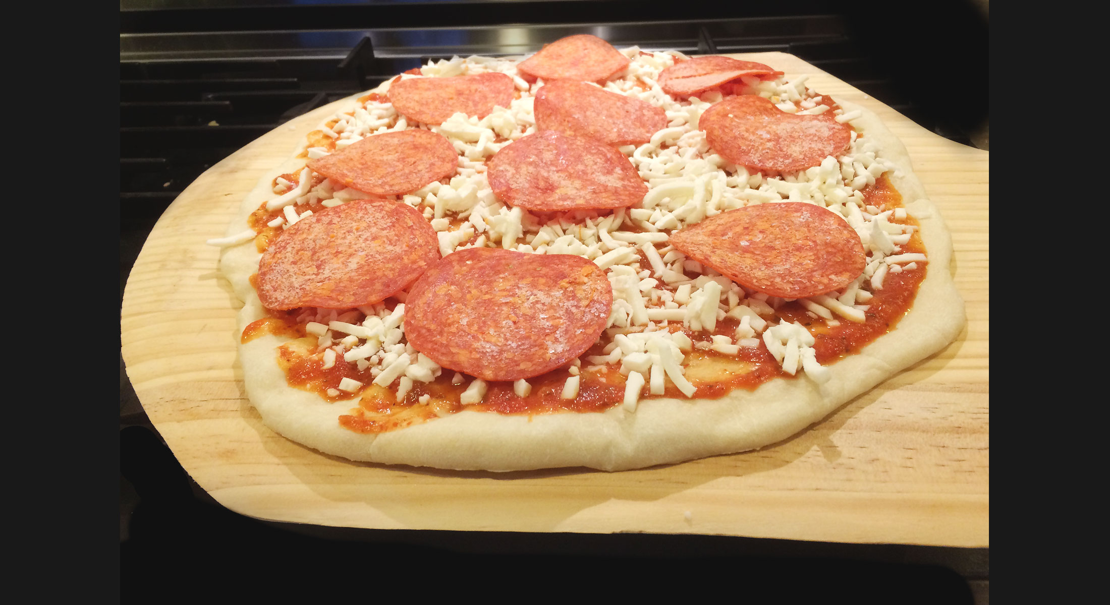 Closeup of pepperoni pizza before it's put in the oven.